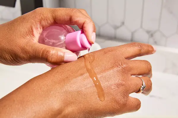 Person tests Glow Recipe Plum Plump Hyaluronic Acid Serum on their hand