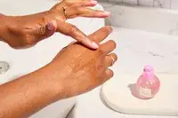 Person tests Glow Recipe Plum Plump Hyaluronic Acid Serum on their hand