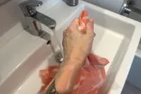 A person lathers the Hanni Shower Scarf with soap