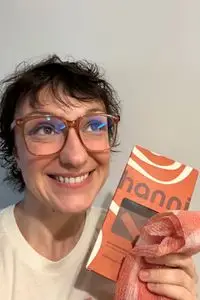 A person holds up the Hanni Shower Scarf and box