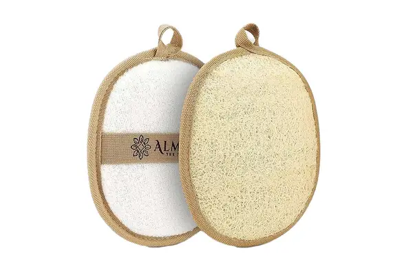 A person holds up the Lather Natural Sea Wool Sponge