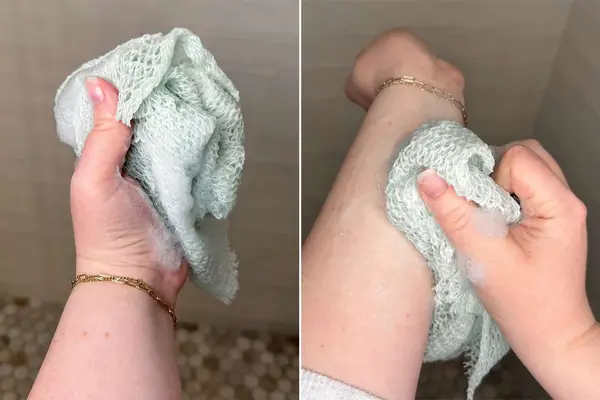 A person scrubs their arm with the LuvScrub Mesh Body Exfoliator
