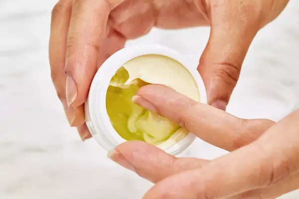 Photos of person’s face before and after using Lâncome Absolue Revitalizing Eye Cream