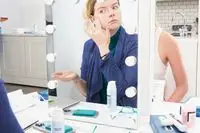 Reflection in mirror of person applying Paula