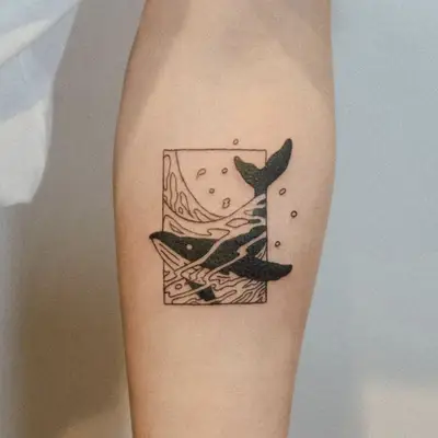 Framed tattoo with wave splash and dark whale bursting out