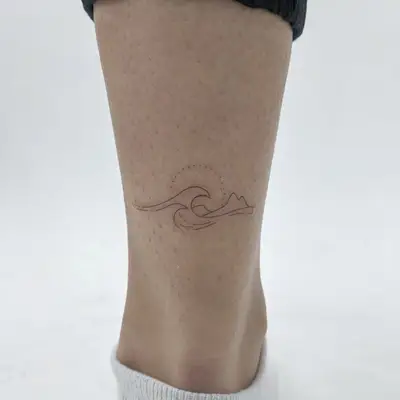 Thin-lined waves tattoo on ankle