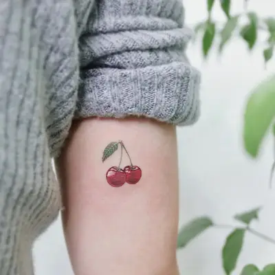 Colorful red cherry tattoo