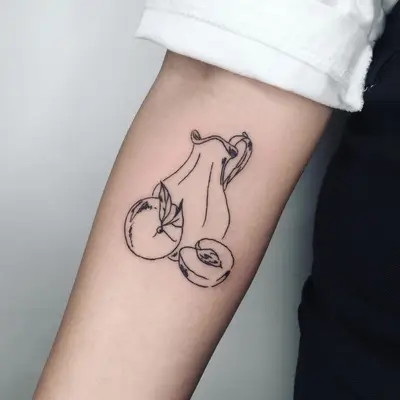 Arm tattoo of a pitcher with a peach