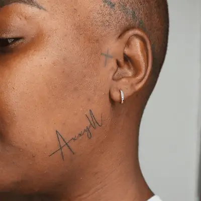 Small cross on the tragus of an ear