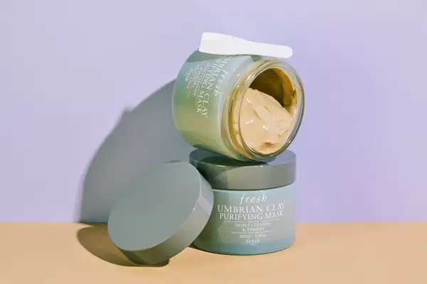 Close-up of a person with their face covered entirely in a skincare product