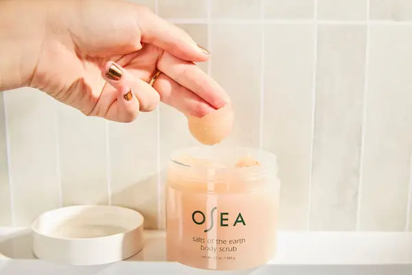 Person puts Osea Salts of the Earth Body Scrub on their fingers