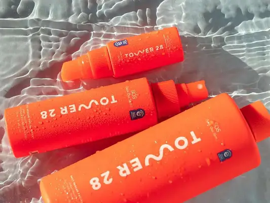 Three bottles of Tower28 SOS sprays in water