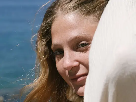 woman with septum piercing staring into sun