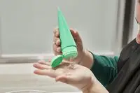 Person dispensing Skinfix Acne+ 2% BHA Cleanser onto hand