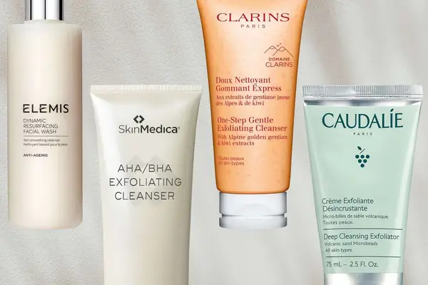 A collage of exfoliating face washes against a cream background, including products by Elemis, SkinMedica, Clarins, and Caudalie