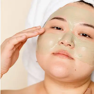person applying clay skincare mask