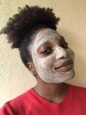 Smiling person with Aztec Secret Indian Healing Clay on face