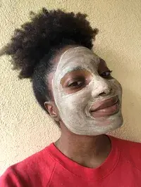 Smiling person with Aztec Secret Indian Healing Clay on face