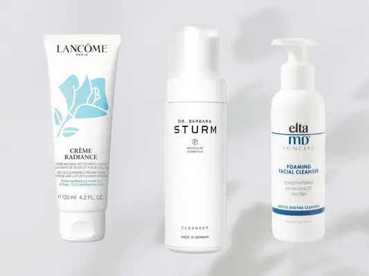 A collage of foam cleansers on a gray background, including Lancome Gentle Cleansing Creamy-Foam and EltaMD Foaming Facial Cleanser