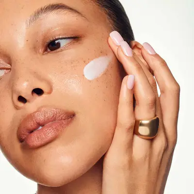 Model applying Sofie Pavitt Face moisturizer