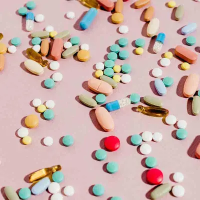 Pills against a pink backdrop