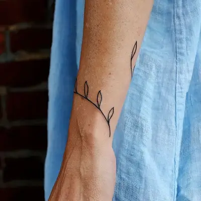 Minimalist plant forearm tattoo
