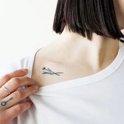Minimalist tattoo below collar bone