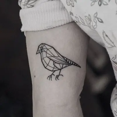 Minimalist bird tattoo on bicep