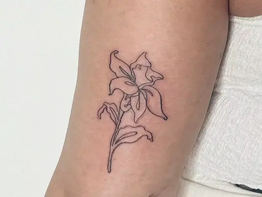 woman with flower tattoo on arm