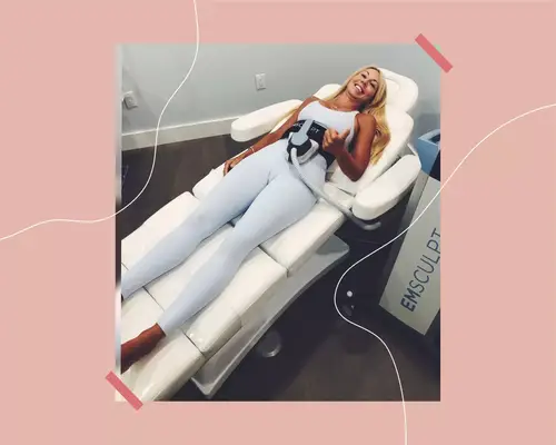 woman laying down while using an emsculpt device