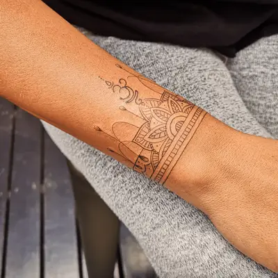 Person with a Sanskrit wristband tattoo