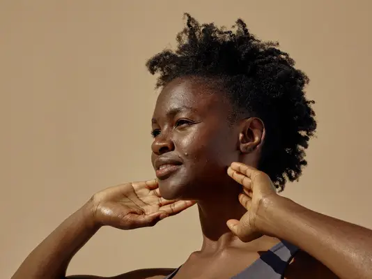 woman with acne standing in sunlight