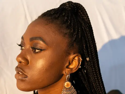 woman with acne standing in sunlight