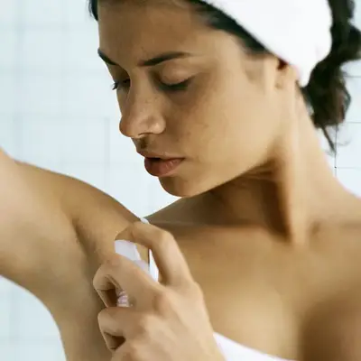 woman applying deodorant 