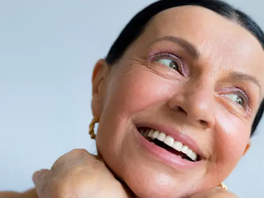 woman smiling with pink eyeshadow