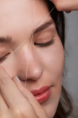 Close-up of woman getting her eyebrows threaded