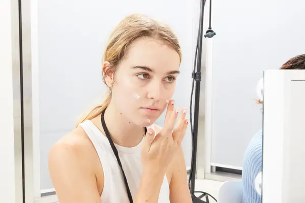 Person applying moisturizer to their face with their fingers