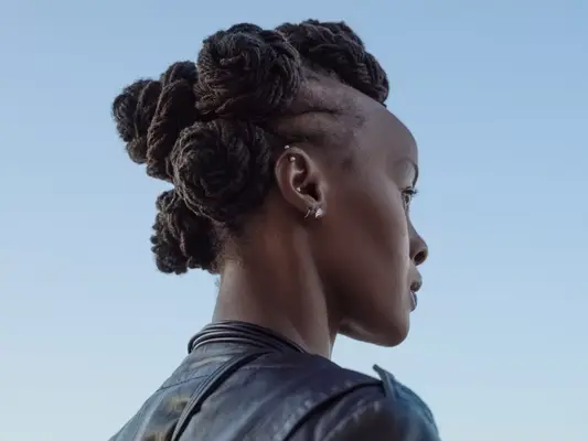 Back view of a model with Bantu knots, showing of four ear piercings. 