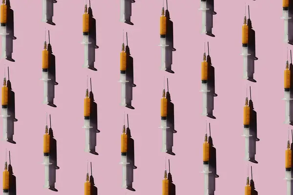 syringes on pink background