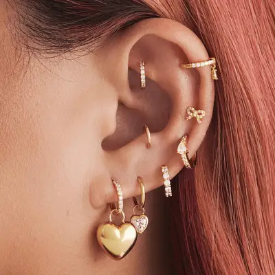 Gold hoop anti-tragus piercing