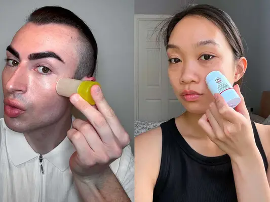 Two individuals applying sunscreen sticks to their faces