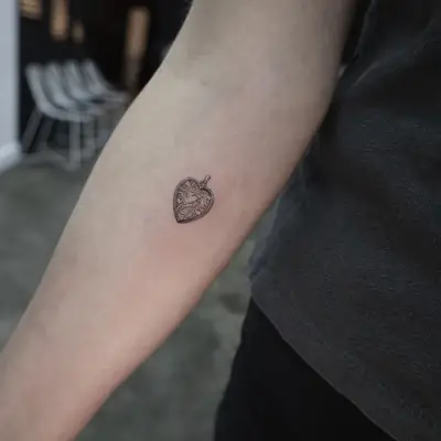 tattoo of a heart-shaped locket