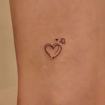 heart tattoo with small heart and butterfly tattoos 