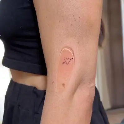 heart tattoo with an arrow through it
