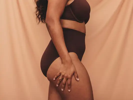 woman standing in brown underwear