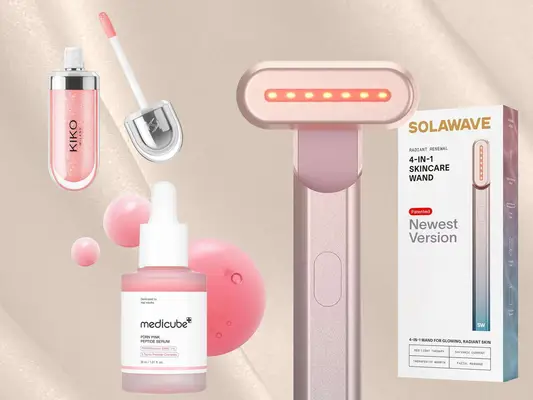 Assorted beauty products on a neutral background, including a skincare wand and various cosmetics