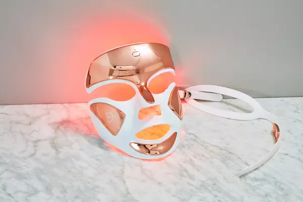 Dr. Dennis Gross DrX SpectraLite FaceWare Pro lit on marble surface