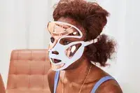 A person wears the Dr. Dennis Gross DRx SpectraLite FaceWare Pro