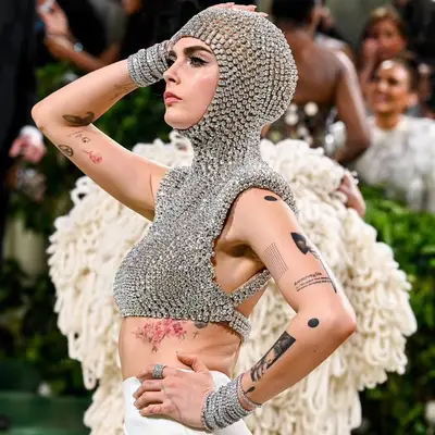 Cara Delevingne showing off sticker sleeve tattoos