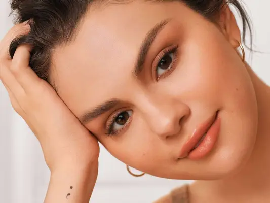Selena Gomez with a fresh makeup look and semicolon tattoo on wrist